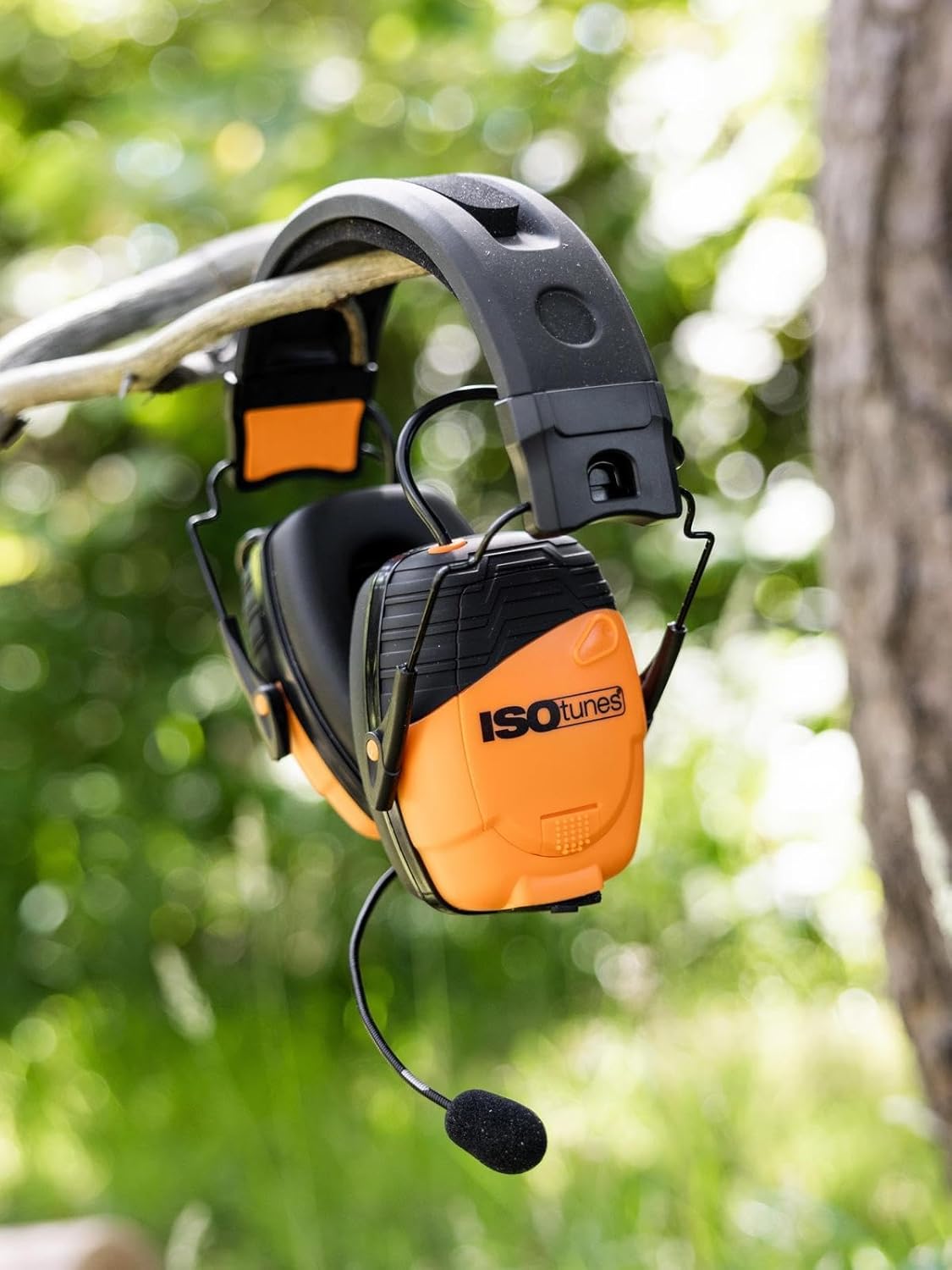 ISOtunes LINK 2.0 ear defenders with boom mic hanging from a branch in a garden